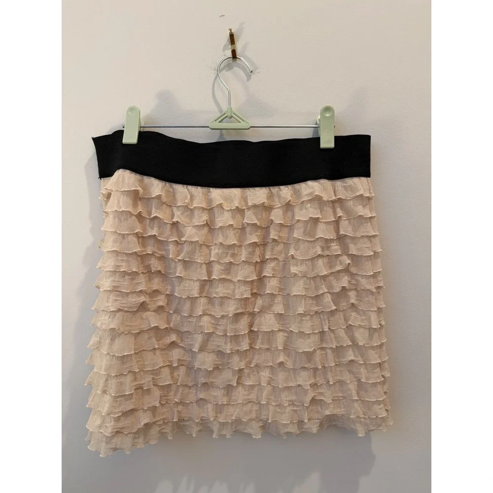 Medium Free People beige ruffle mini skirt thick black elastic waistband.